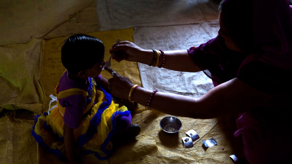 Administering a deworming pill in Neemrana, India