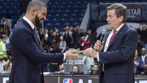Toronto's Mayor John Tory, right, hands Drake the key to the city ahead of the celebrity all-star game in Toronto on Friday, Feb. 12, 2016. (Chris Young / THE CANADIAN PRESS)