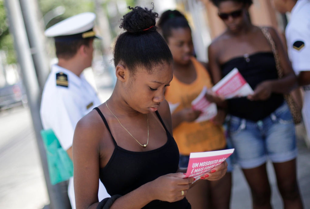 Woman reads pamphlet on Zika
