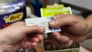 A consumer pays with a credit card at a store Tuesday, July 6, 2010 in Montreal. (THE CANADIAN PRESS/Ryan Remiorz)