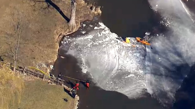 Police officers chip away ice as they search for a missing kayaker in the Credit River on Monday, Feb. 22, 2016. 