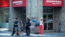 People pass by a Shoppers Drug Mart in downtown Toronto on Monday, July 15, 2013. (The Canadian Press/Graeme Roy)