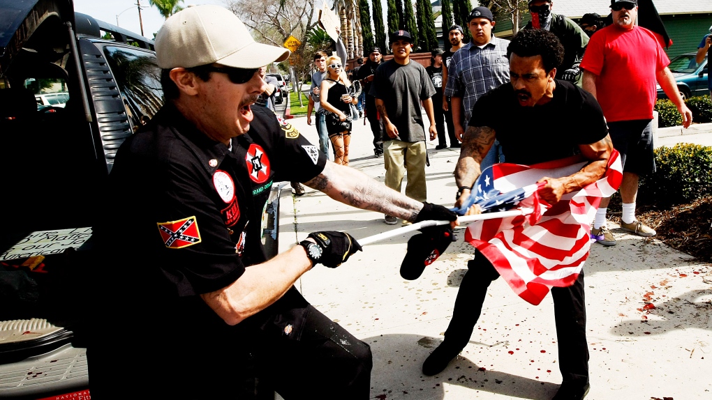 Klansman fights protestor for American flag
