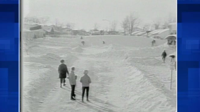 Residents walk through snow-covered streets with massive snow piles after the winter storm of March 4, 1966. 