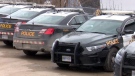 Ontario Provincial Police cruisers sit in a parking lot. 