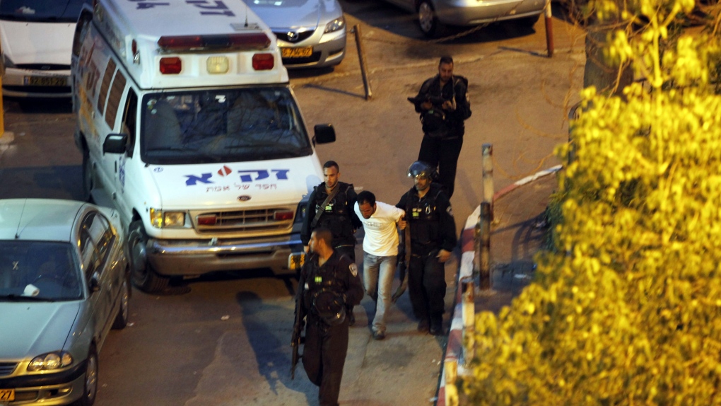 Israeli policemen arrest a Palestinian attacker