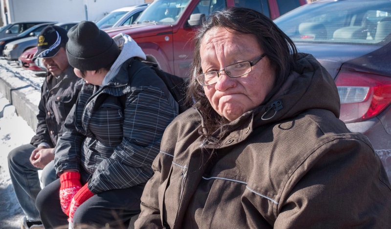 Bessie Strang pauses as she tells her story while sitting with other homeless friends, Friday, March 4, 2016 in Thunder Bay, Ont. (THE CANADIAN PRESS / Paul Chiasson)