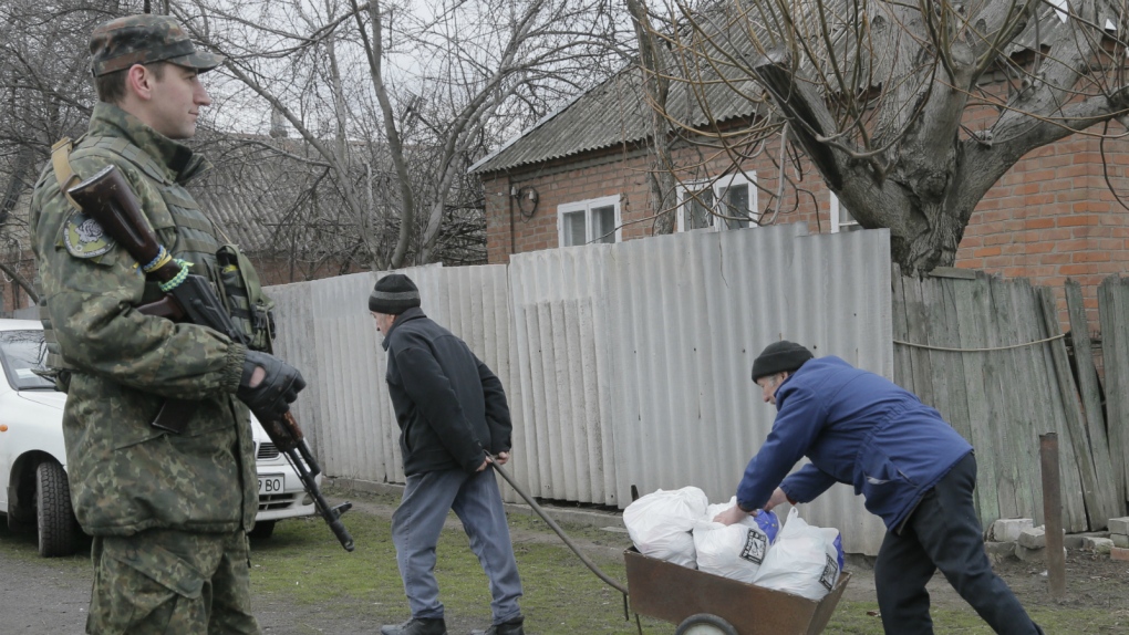 Ukrainian soldiers distribute aid for citizens