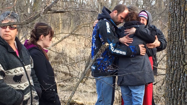 Thomas Martens and Destiny Turner, parents of the deceased toddler, stood together by the creek as friends and family comforted them.