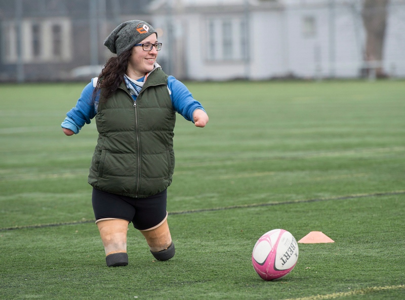 Lindsay Hilton, who was born without full arms and legs, coaches rugby at Dalhousie University in Halifax on March 28, 2016. (Andrew Vaughan / The Canadian Press)