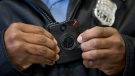In this Dec. 11, 2014, file photo, a Philadelphia Police officer demonstrates a body-worn camera being used as part of a Philadelphia Police pilot project in the department's 22nd District, in Philadelphia. (AP Photo/Matt Rourke)