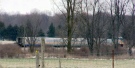A train is seen stopped following a fatal collision between a car and a Via Rail train near the community of Melbourne, Ont., on Monday, April 4, 2016.