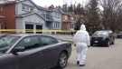 A police forensic investigator is seen outside a Richmond Hill home where two people were found dead on April 7. (Janice Golding/CTV Toronto)
