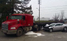 A flatbed transport truck and a grey sedan collided at Jefferson and Queen Elizabeth Drive Monday, April 11, 2016. (Arms Bumanlag / CTV Windsor)