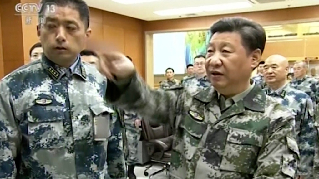 Chinese President Xi Jinping, right, in uniform