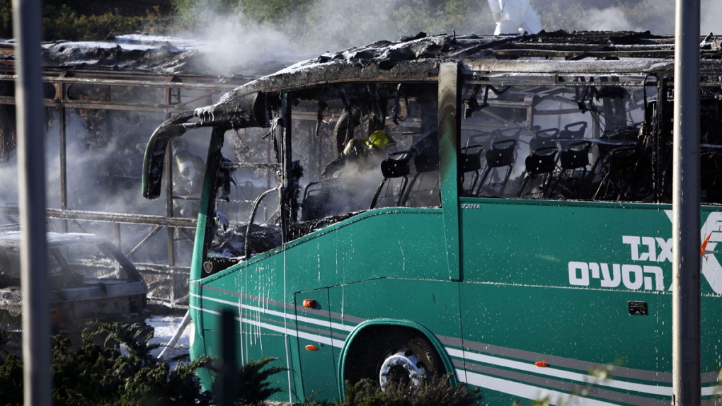 Firefighter inside a burnt bus in Jerusalem