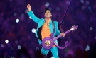 In this Feb. 4, 2007 file photo, Prince performs during the halftime show at the Super Bowl XLI football game at Dolphin Stadium in Miami. The halftime show has become one of the year's top cultural moments, so anticipated that it is commonly seen by more people than the game itself. (AP Photo/Chris O'Meara, File)