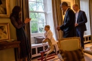 In this hand out photo released by Kensington Palace, Prince George, centre, talks to Kate, the Duchess of Cambridge after meeting U.S. President Barack Obama, second right, and First Lady Michelle Obama, at Kensington Palace, London, Friday April 22, 2016. Prince William is at right. (Pete Souza / Kensington Palace via AP)