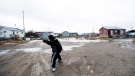 Teenage boys throw rocks in the northern Ontario First Nations reserve in Attawapiskat, Ont., on Monday, April 16, 2016. (Nathan Denette / THE CANADIAN PRESS)