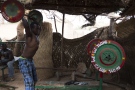 A man lifts a barbell at the MM Club, a weight room in the neighbourhood of Dapoya, Ouagadougou. (AFP PHOTO / NABILA EL HADAD)