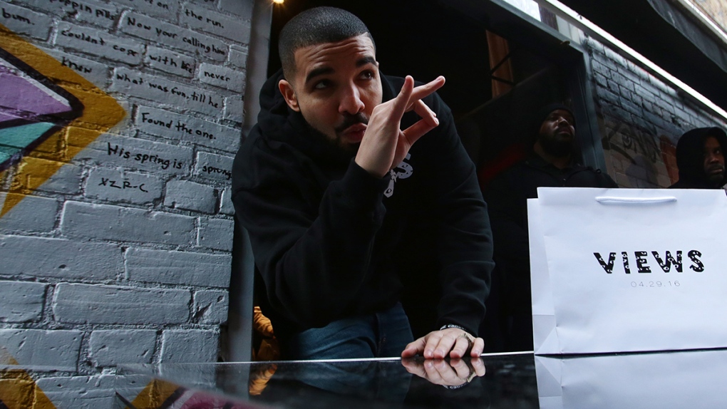 Toronto rapper Drake poses for photos as he hands 