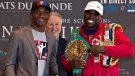 Adonis "Superman" Stevenson, right, and Sakio "The Scorpion" Bika pose with Promoter Yvon Michel, centre, in Quebec City, on Wednesday, April 1, 2015 in Quebec City. (THE CANADIAN PRESS/Jacques Boissinot)