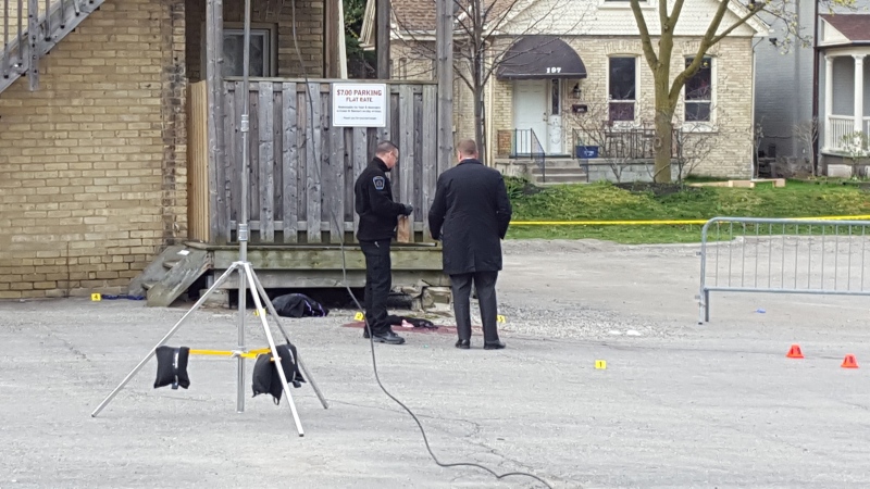 Investigators look through evidence at the scene of an overnight shooting on John Street downtown on Friday, April 29, 2016. (Justin Zadorsky / CTV London)