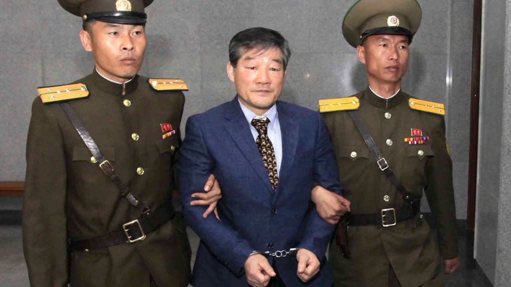 Kim Dong Chul being escorted to his trial