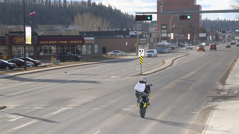 Wood Buffalo RCMP released a still taken from a traffic camera showing a suspect motorcycle rider popping a wheelie on a Fort McMurray road. Supplied.