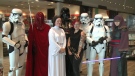 Star Wars fan, Vicky Cosenzo, poses with members of the Capital City Garrison in Ottawa on May the 4th, 2016