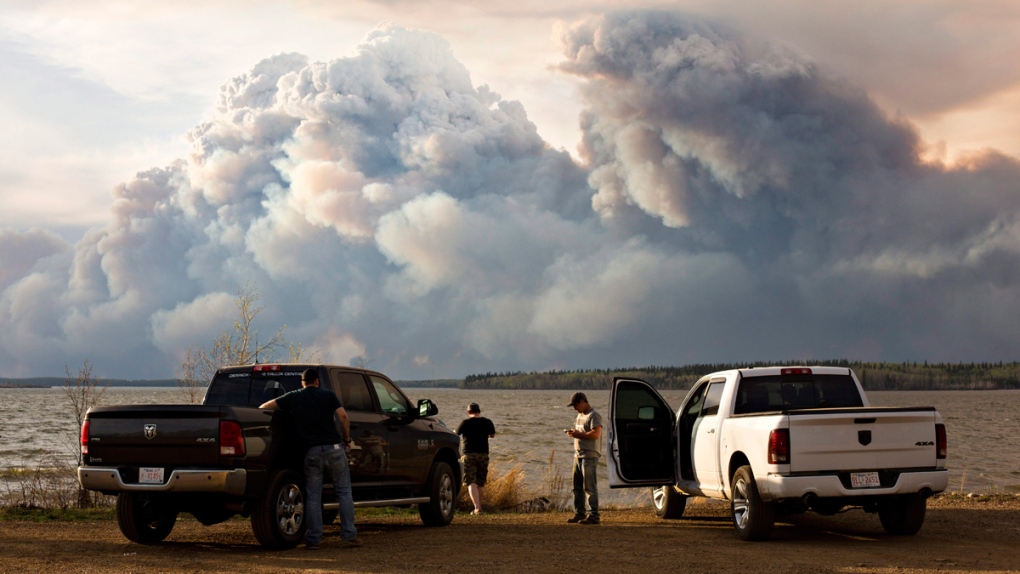 Evacuees watch the wildfire near Fort McMurray