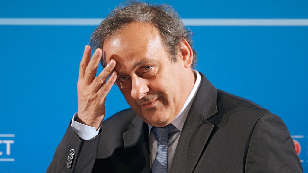 Michel Platini arrives at a press conference