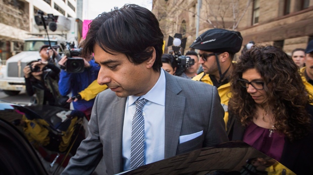 Former CBC host Jian Ghomeshi leaves court with his sister Jila, right, after signing a peace bond in Toronto, Wednesday, May 11, 2016. THE CANADIAN PRESS/Mark Blinch