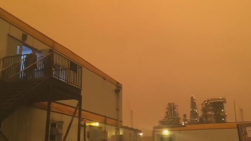 An orange glow hovering over the Suncor plant