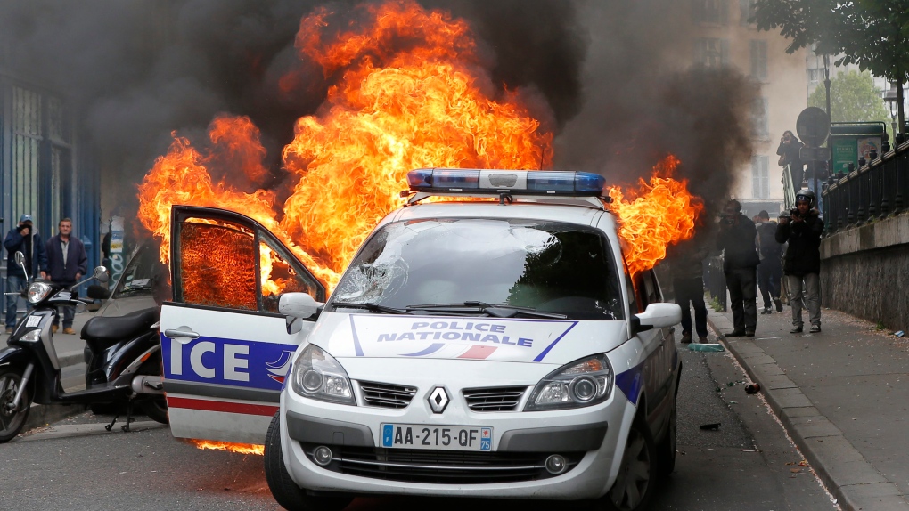 A police car burns in France