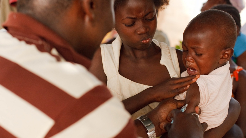 Injecting a young boy with yellow fever vaccine 