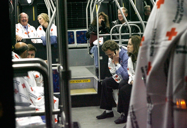 Survivors of the US Airways plane crash in the Hudson River wait for a bus to take them from a First Aid center in Weehawken, N.J. back to La Guardia Airport, Thursday, Jan. 15, 2009. (AP / Stuart Ramson) 