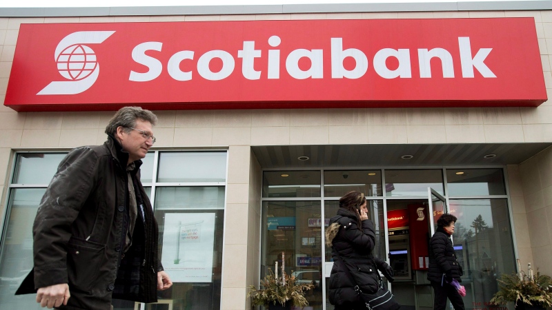 People walk past and leave Scotiabank in Toronto on Thursday, April 9, 2015. (THE CANADIAN PRESS/Nathan Denette)