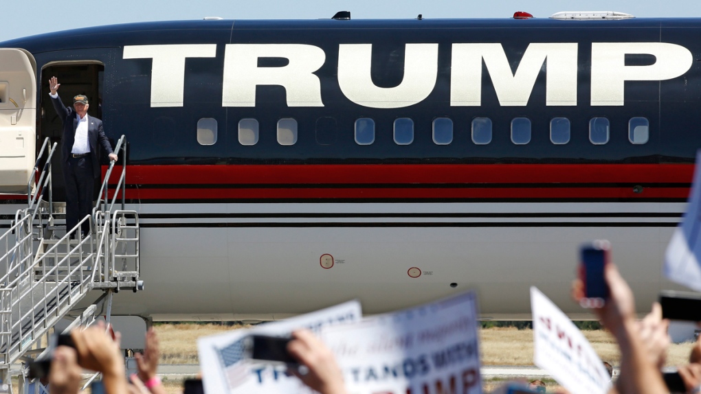 Donald Trump disembarks from his plane