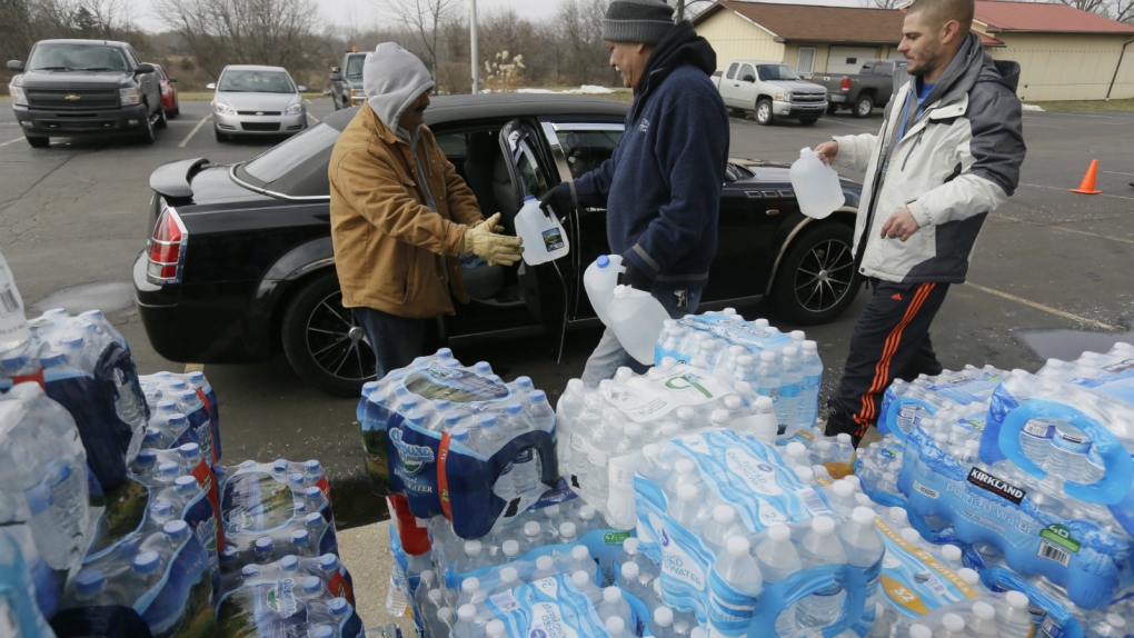 Volunteers load vehicles with water in Flint