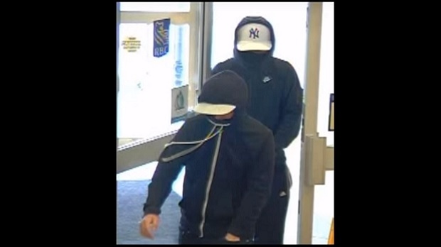 Police are searching for the two males seen in this screen grab from a security camera video at a bank in Scarborough. (Toronto Police)
