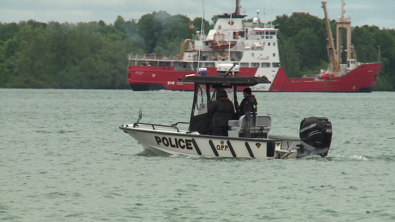 An O.P.P. boat patrols alongside a Canadian Coast Guard vessel on the St. Lawrence River, June 8, 2016