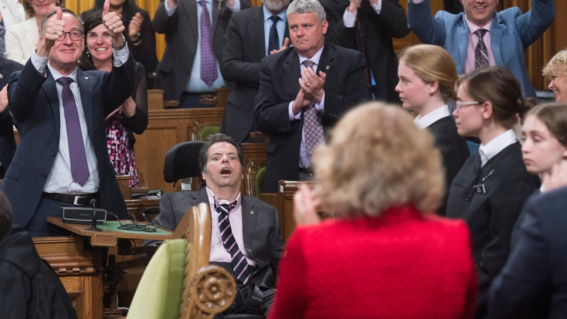 Members of Parliament applaud Ottawa-Vanier MP Mauril Belanger as his private members bill on changing the Canadian anthem is debated in the House of Commons Friday June 10, 2016 in Ottawa. (Adrian Wyld / THE CANADIAN PRESS)