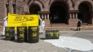 Protesters are seen outside Queen's Park with barrels of an unknown substance on June 23. (Twitter/@hussansk)