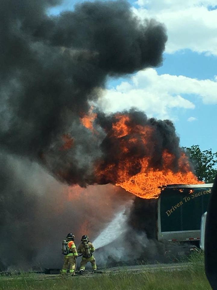 Firefighters battle large flames in the fiery 402 crash near London, Ont, on Monday, June 27, 2016. (Aimee Munshaw)