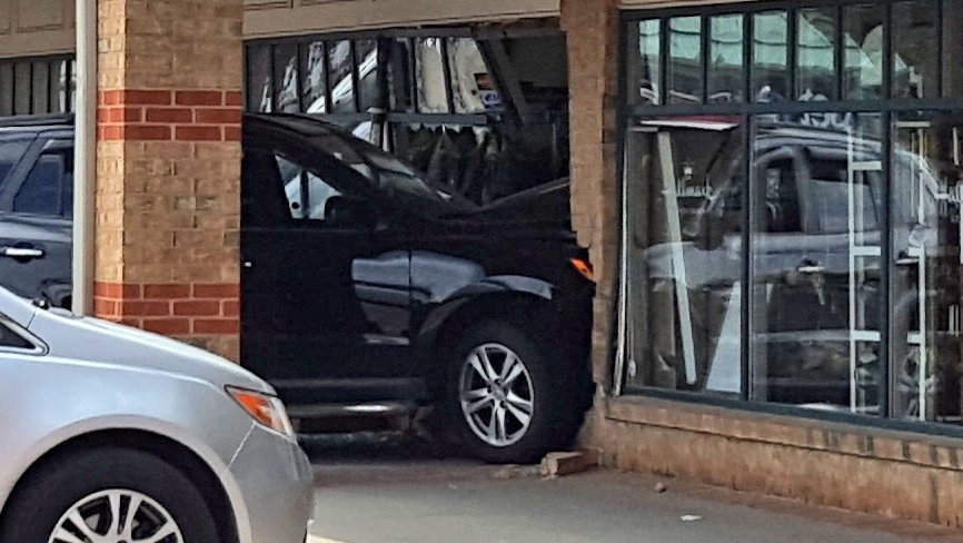 SUV crashes into dry cleaner