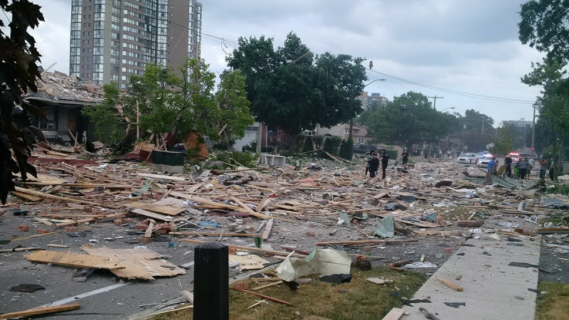 Debris litters a street after a house explosion in Mississauga, Ont., Tuesday, June 28, 2016. (Zeljko Zidaric / THE CANADIAN PRESS)