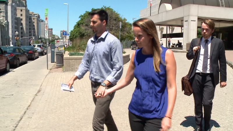 Ottawa teacher Kyla Cowan-Wilson leaves courthouse with husband (left) and lawyer (right).