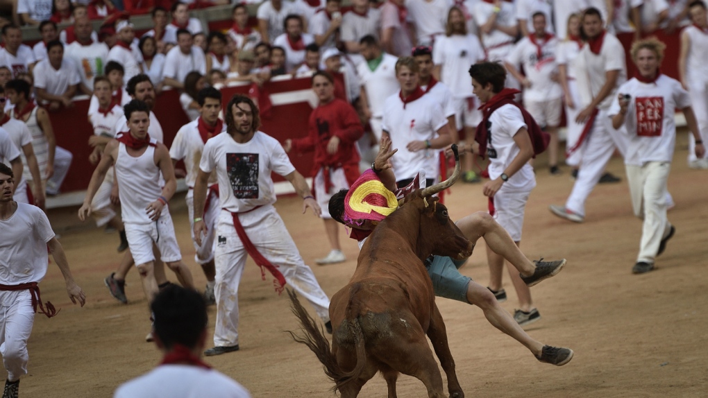 People take part in the Running of the Bulls