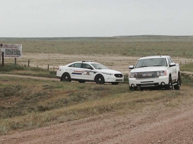 An RCMP vehicle is seen near the Ponteix landfill, where police say two bodies were discovered on Thursday, July 7, 2016.